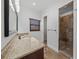 Tasteful bathroom with granite countertops, a stone-tiled shower, and sleek fixtures, creating a spa-like experience at 3576 San Remo Ter, Sarasota, FL 34239