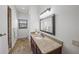 Elegant bathroom with a dark wood vanity, stone countertop, and modern fixtures, offering a luxurious feel at 3576 San Remo Ter, Sarasota, FL 34239