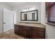 Well-lit bathroom featuring granite countertop vanity and stone floors at 3576 San Remo Ter, Sarasota, FL 34239