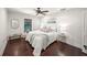 Bright bedroom featuring hardwood floors, and a bed with a white comforter and decorative pillows at 3576 San Remo Ter, Sarasota, FL 34239