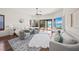 Bright bedroom with water views, hardwood floors, a ceiling fan, and stylish, comfortable furnishings at 3576 San Remo Ter, Sarasota, FL 34239