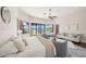 Light filled bedroom offers water views, hardwood floors, comfortable seating and generous natural light at 3576 San Remo Ter, Sarasota, FL 34239