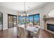 Bright dining room with water views, chandelier, fireplace and access to the outdoor patio at 3576 San Remo Ter, Sarasota, FL 34239
