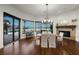 Elegant dining room with hardwood floors, a fireplace and water views from the large windows at 3576 San Remo Ter, Sarasota, FL 34239