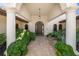 Arched front entrance with brick pavers, lush plants and columns at 3576 San Remo Ter, Sarasota, FL 34239