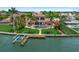 Waterfront home featuring lush landscaping, swimming pool, private dock, and stunning curb appeal at 3576 San Remo Ter, Sarasota, FL 34239