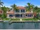 Waterfront home with lush landscaping, swimming pool, outdoor seating and private boat dock at 3576 San Remo Ter, Sarasota, FL 34239
