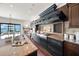 Close-up view of kitchen features granite countertops, stainless steel appliances, and custom range hood at 3576 San Remo Ter, Sarasota, FL 34239
