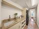 Well-appointed laundry room with ample counter space, storage cabinets, and modern washer/dryer, ensuring practicality at 3576 San Remo Ter, Sarasota, FL 34239