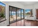 Bright living room featuring hardwood floors, large windows, and an outdoor patio overlooking the water at 3576 San Remo Ter, Sarasota, FL 34239