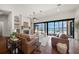 Bright living room with water views, hardwood floors, fireplace, neutral furniture, and modern decor at 3576 San Remo Ter, Sarasota, FL 34239