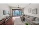 Open living room with hardwood floors, modern decor, and a large sliding glass door that leads to a waterfront balcony at 3576 San Remo Ter, Sarasota, FL 34239