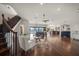 Bright, open living area features hardwood floors, staircase, and expansive water views through sliding glass doors at 3576 San Remo Ter, Sarasota, FL 34239