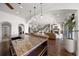 Open-concept space features an expansive kitchen island and flows into a living area with a fireplace at 3576 San Remo Ter, Sarasota, FL 34239