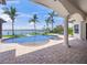 Beautiful pool area with scenic waterfront views, palm trees, and patio, offering relaxation and outdoor enjoyment at 3576 San Remo Ter, Sarasota, FL 34239