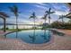 Beautiful pool and spa surrounded by a paved patio and waterfront views at sunset at 3576 San Remo Ter, Sarasota, FL 34239