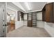 Walk-in closet with custom shelving, carpet flooring, and easy access to the main living space at 3576 San Remo Ter, Sarasota, FL 34239