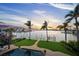 Breathtaking waterfront view showcasing lush landscaping, a private dock, and tranquil waters, perfect for serene living at 3576 San Remo Ter, Sarasota, FL 34239