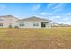 The back of the house overlooks a spacious lawn at 3834 Silver Strand Trl, Palmetto, FL 34221