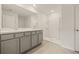 Bathroom featuring double sinks with marble countertops and a walk-in shower at 3834 Silver Strand Trl, Palmetto, FL 34221