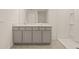 Well-lit bathroom showcasing a double vanity and a glass-enclosed shower at 3834 Silver Strand Trl, Palmetto, FL 34221