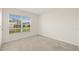 Carpeted bedroom with a window offering a view of the neighborhood at 3834 Silver Strand Trl, Palmetto, FL 34221