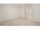 Light-filled bedroom with carpeting, a doorway, and neutral color palette at 3834 Silver Strand Trl, Palmetto, FL 34221