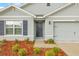A close up of a charming home featuring a two-car garage, and lovely landscaping at 3834 Silver Strand Trl, Palmetto, FL 34221