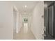 An extended hallway with multiple doors and tile flooring at 3834 Silver Strand Trl, Palmetto, FL 34221