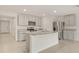 A well-lit kitchen featuring stainless steel appliances, granite countertops, and plenty of cabinet space at 3834 Silver Strand Trl, Palmetto, FL 34221