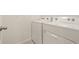 Bright laundry room featuring a full-size, white washer and dryer at 3834 Silver Strand Trl, Palmetto, FL 34221