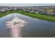 A tranquil pond featuring a fountain is surrounded by lush green grass at 3834 Silver Strand Trl, Palmetto, FL 34221