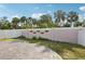 Private backyard with a concrete slab and a secure fence adorned with hanging planters at 4012 Willow Hammock Dr, Palmetto, FL 34221