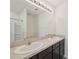 A bathroom with double sinks, and a large mirror with vanity lights at 4012 Willow Hammock Dr, Palmetto, FL 34221