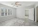 A sun-filled bedroom featuring an open doorway and a shuttered window at 4012 Willow Hammock Dr, Palmetto, FL 34221