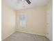Light-filled bedroom with neutral carpeting and a shuttered window at 4012 Willow Hammock Dr, Palmetto, FL 34221