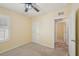 Cozy bedroom features a ceiling fan and neutral carpeting for a comfortable and inviting atmosphere at 4012 Willow Hammock Dr, Palmetto, FL 34221