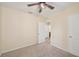 A bright bedroom features a modern ceiling fan and two entryways with neutral walls and carpet at 4012 Willow Hammock Dr, Palmetto, FL 34221