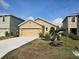 Inviting single-story home with a well-manicured lawn, a palm tree and a two-car garage at 4012 Willow Hammock Dr, Palmetto, FL 34221