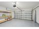 Clean garage with epoxy flooring and shelving, perfect for storage or hobbies at 4012 Willow Hammock Dr, Palmetto, FL 34221