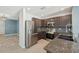 Modern kitchen featuring stainless steel appliances, dark cabinetry, and granite countertops at 4012 Willow Hammock Dr, Palmetto, FL 34221