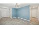 This is a living room featuring stylish gray floors and light blue accent wall at 4012 Willow Hammock Dr, Palmetto, FL 34221