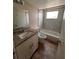 Well-lit bathroom featuring tiled floor and vanity at 4035 S School Ave # D3, Sarasota, FL 34231