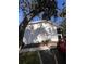 Exterior elevation with shadow from a big tree in front at 4035 S School Ave # D3, Sarasota, FL 34231