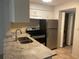 Kitchen features stainless steel appliances, and tiled floor at 4035 S School Ave # D3, Sarasota, FL 34231