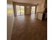 Open-concept living area features neutral tile floors and access to outdoor living spaces at 4035 S School Ave # D3, Sarasota, FL 34231