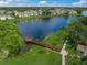 Beautiful aerial view of a community lake, lush landscaping and mature trees at 4037 Crockers Lake Blvd # 17, Sarasota, FL 34238