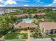 An aerial view of the community clubhouse, swimming pool and other common areas surrounded by lush greenery and landscaping at 4037 Crockers Lake Blvd # 17, Sarasota, FL 34238