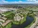 Aerial view of a community near a lake, offering serene waterfront living amidst shopping, dining and nature at 4037 Crockers Lake Blvd # 17, Sarasota, FL 34238