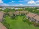 Beautifully landscaped condo community with lush green lawns and mature trees at 4037 Crockers Lake Blvd # 17, Sarasota, FL 34238